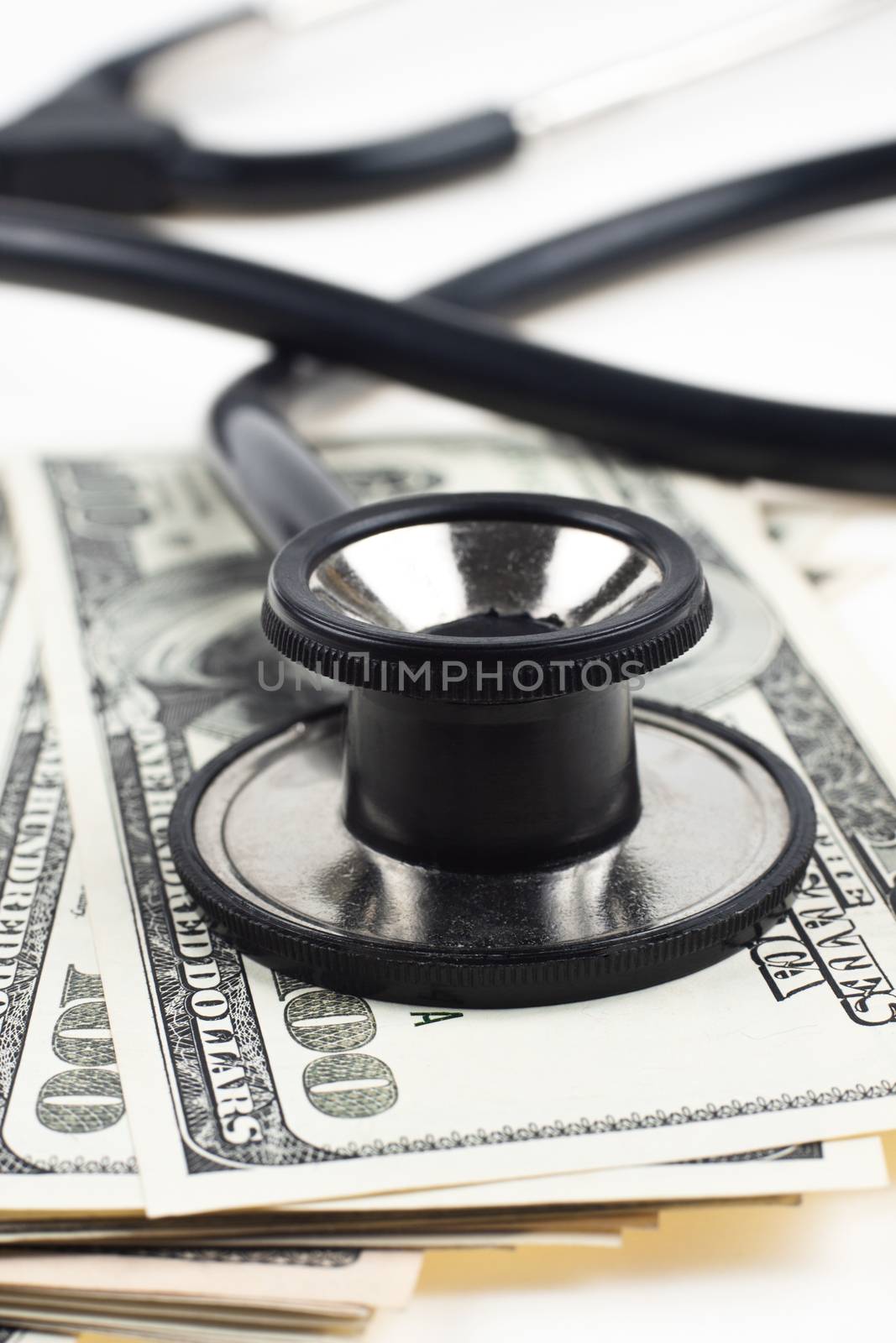 consulting dollars with a black thethoscope close-up on white background