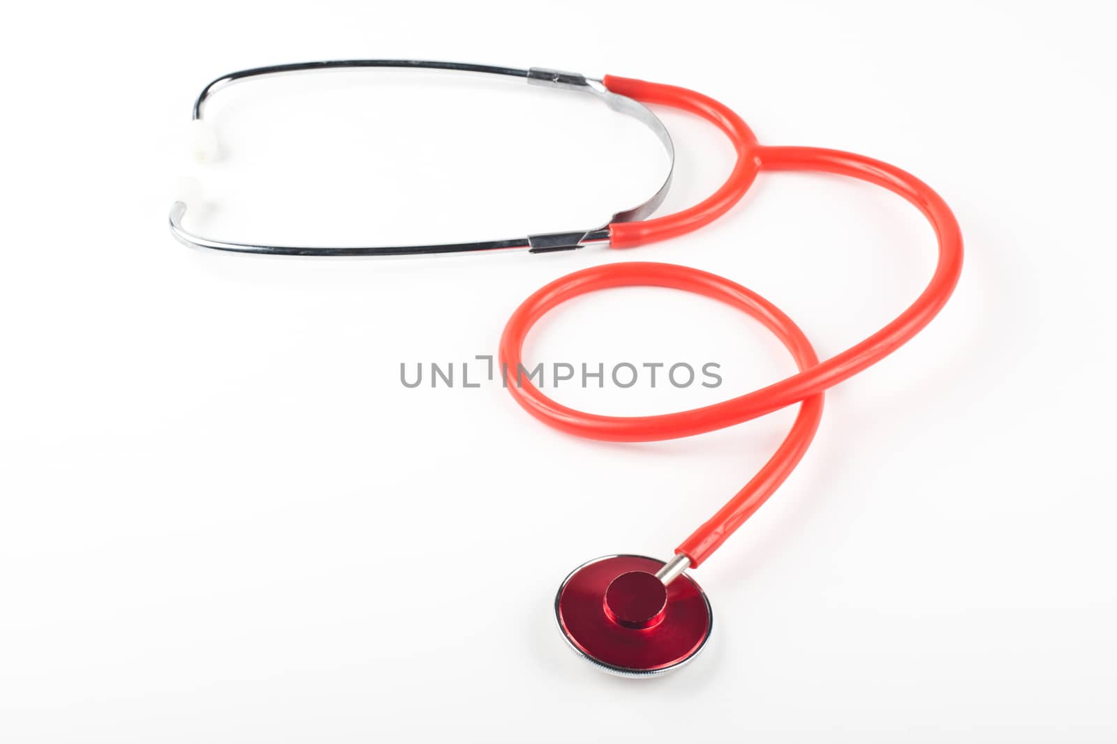 red stethoscope close-up isolated on white background