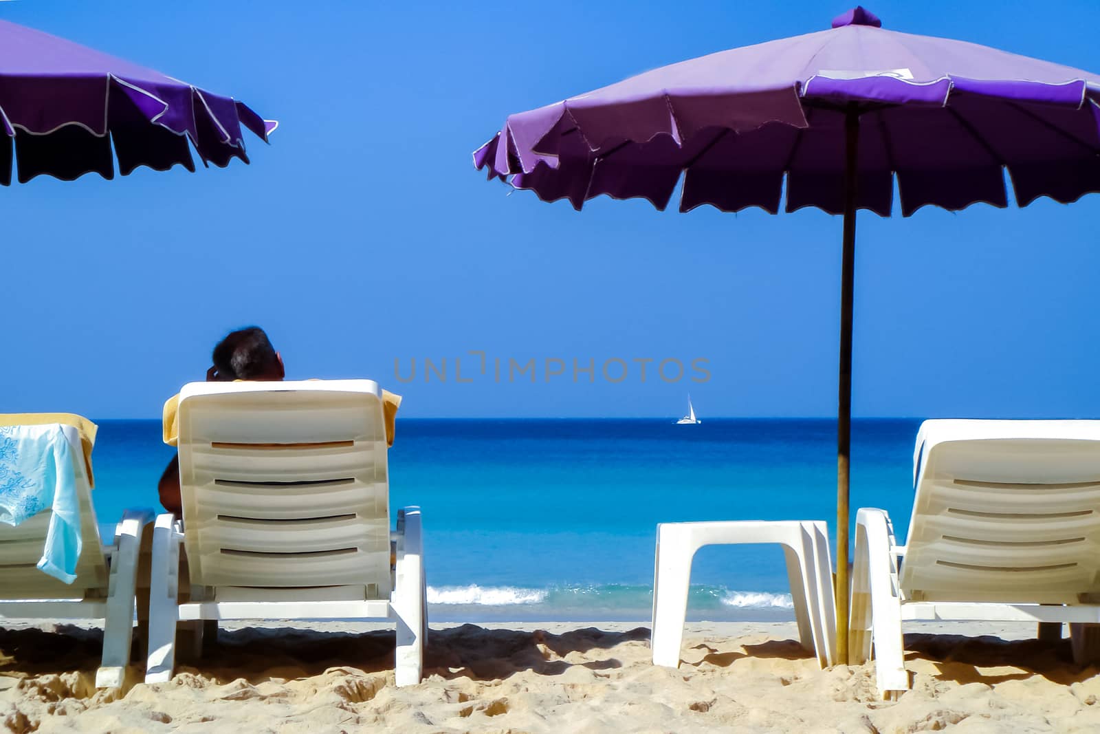 Vacation in tropical countries. Beach chairs and umbrellas on the beach with sea view.
