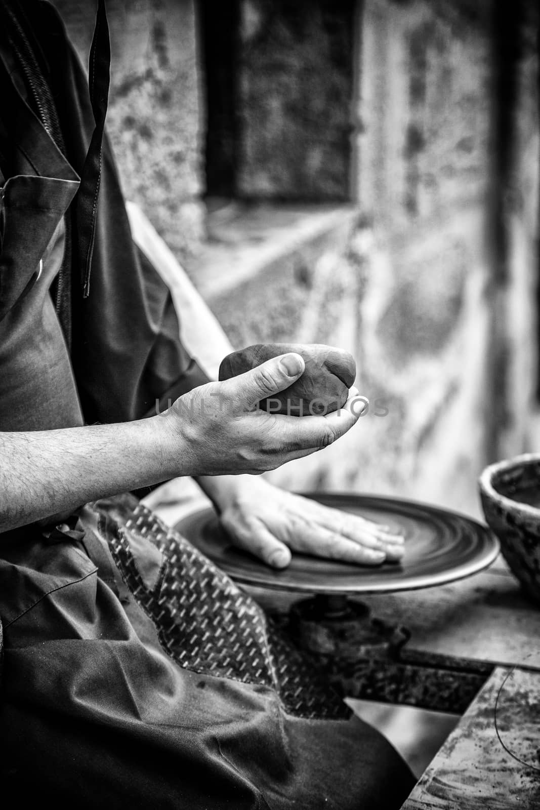 Hands of man working and shaping clay, potter in pottery, craft detail, creation