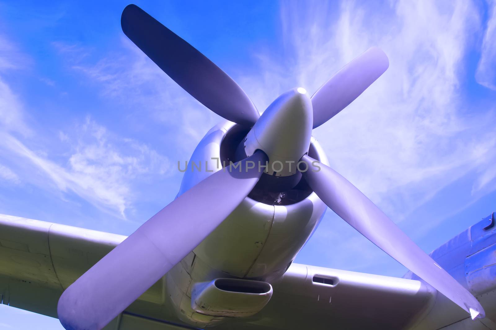 Aircraft propeller on the wing, blue sky background