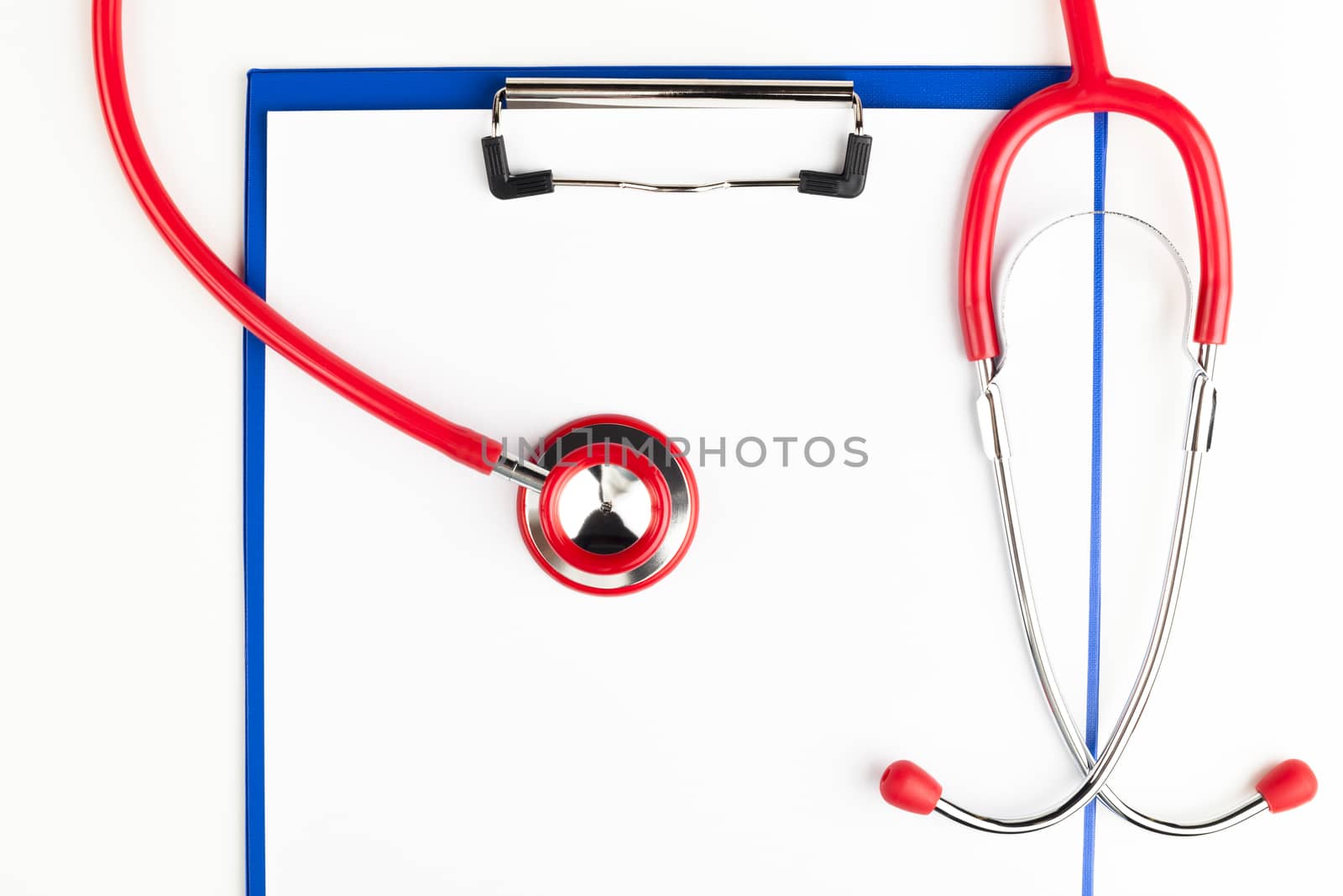 Red stethoscope on a empty  blue clipboard  crop isolated on white background