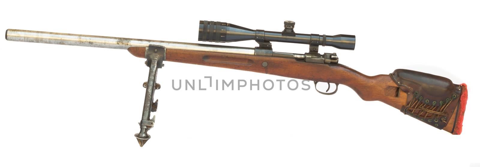 Old Sniper Rifle with scope atached on a tripod isolated on white background