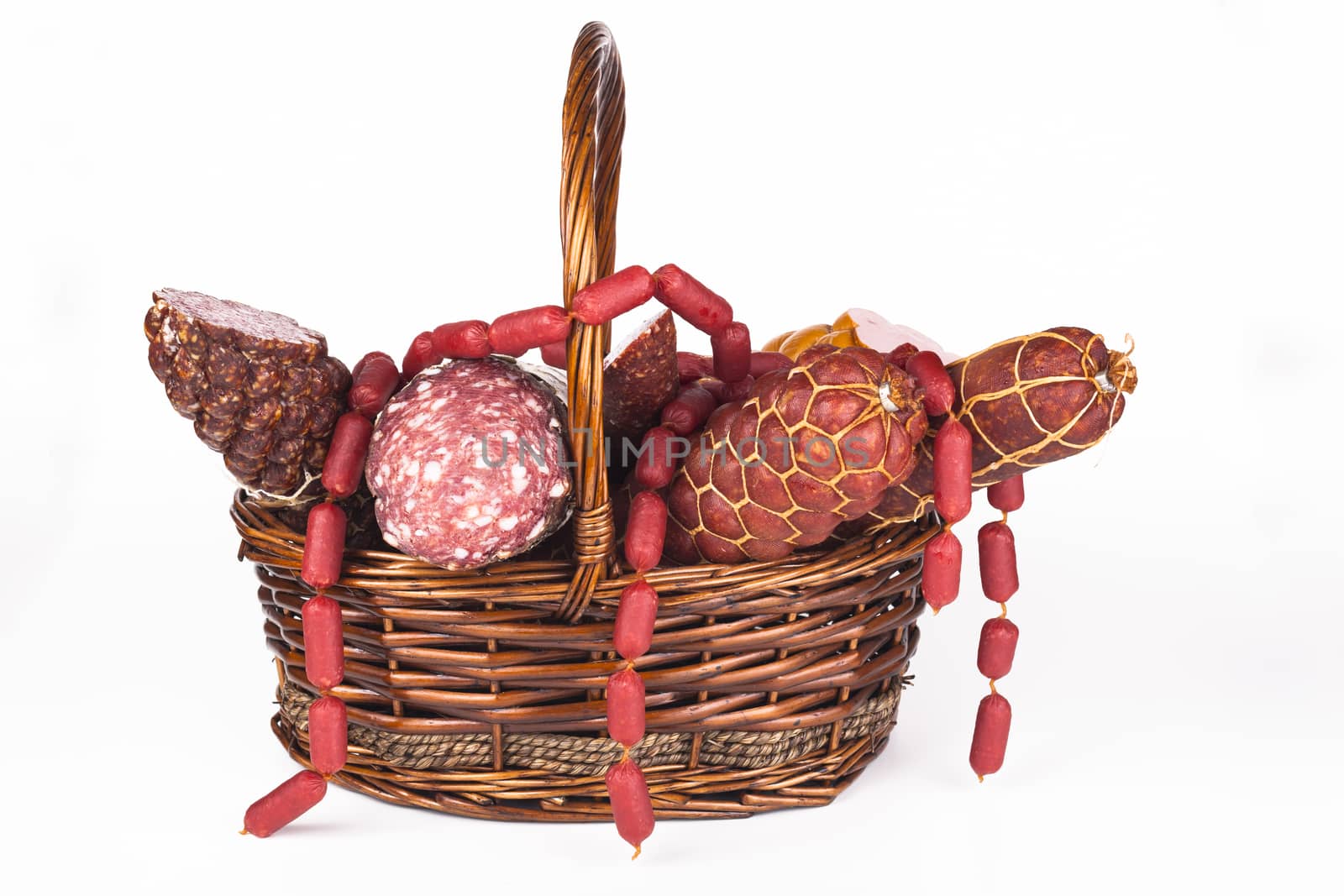 Various salami products in a basket isolated on white background