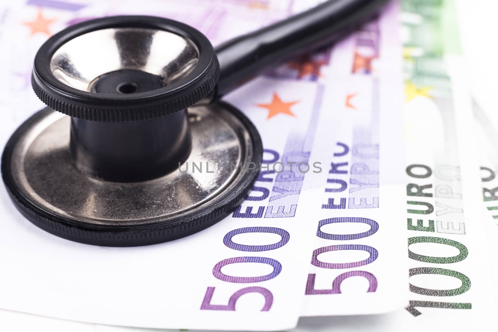 Black stethoscope close-up on top of euro bills