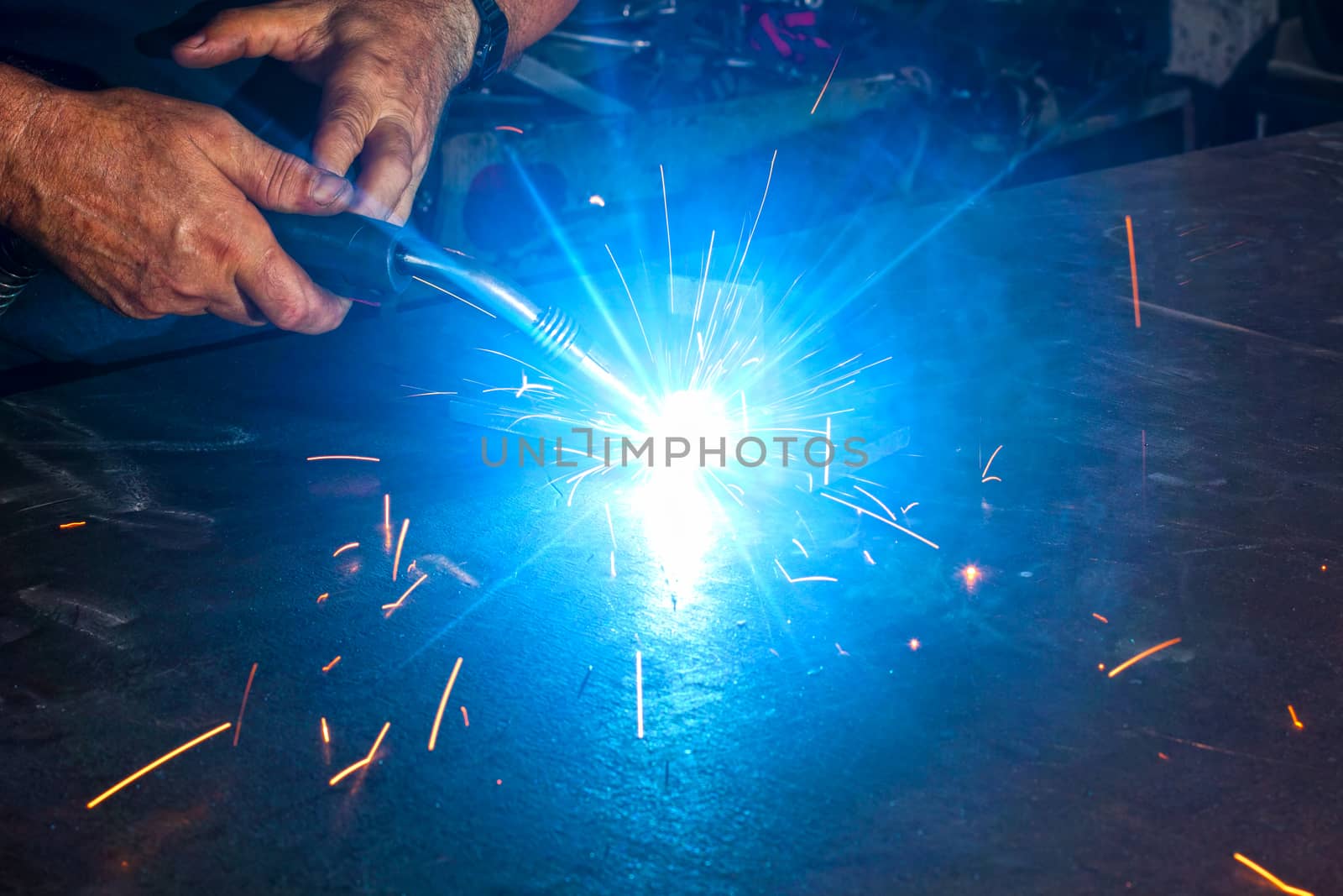 welding close-up bright light and two hands working