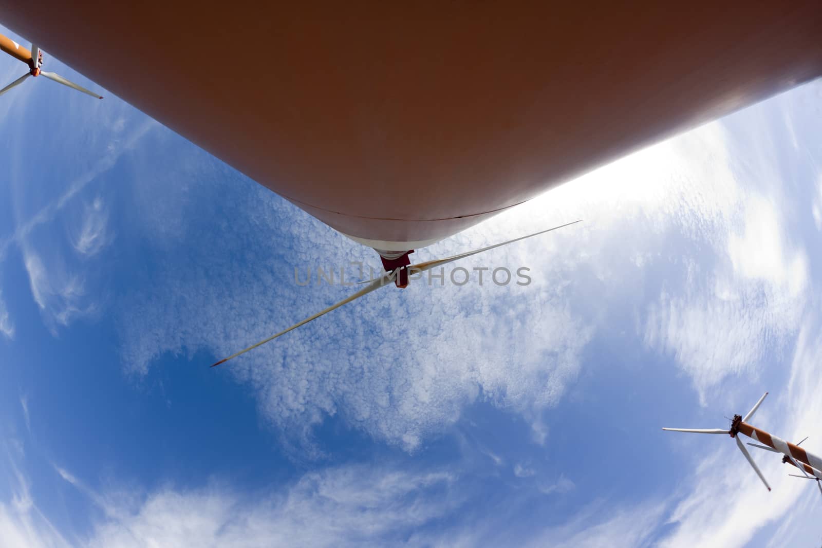 ornage wind turbine wide wiew  with blue sky