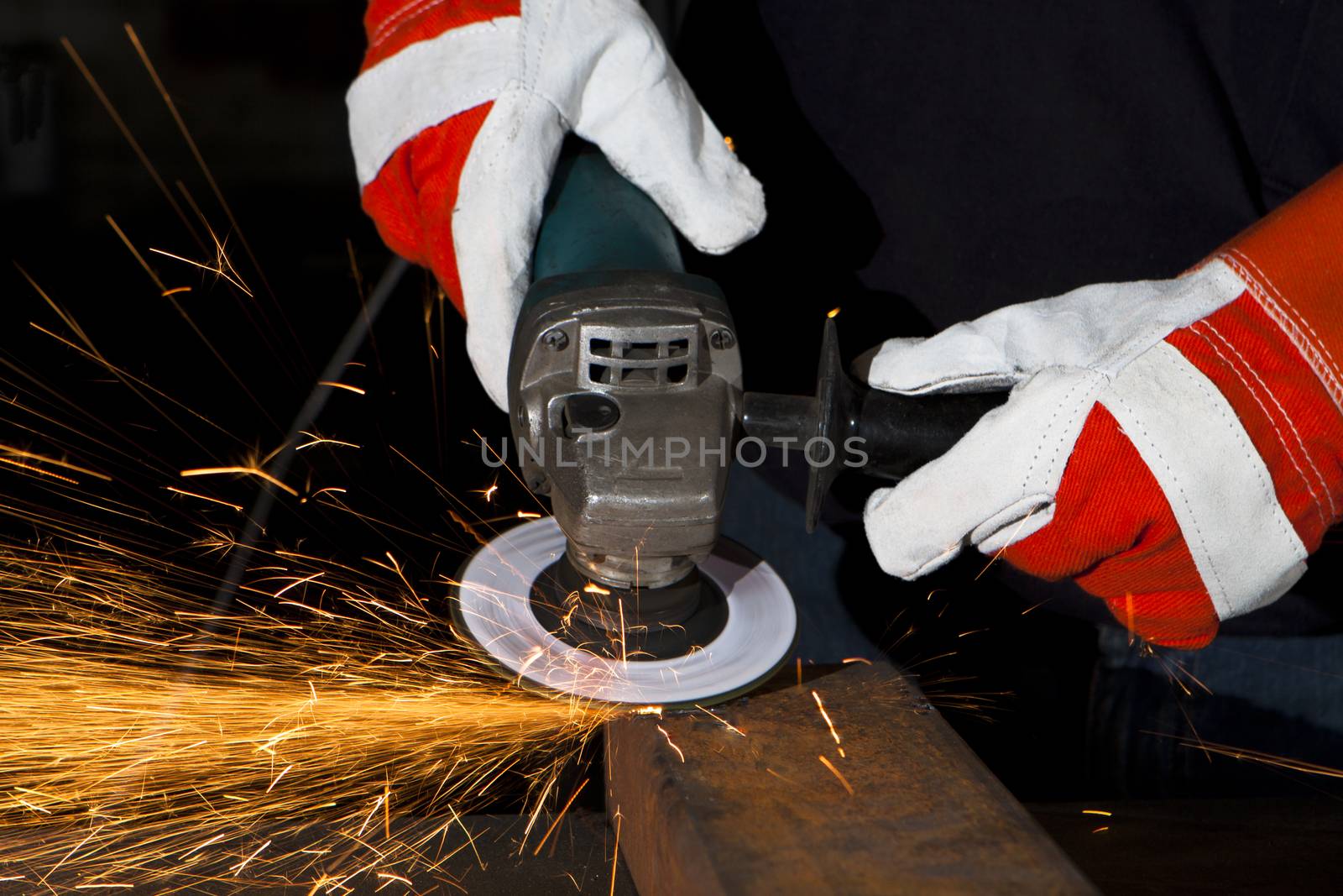 orange sparks during metal grinding in heavy industry plant