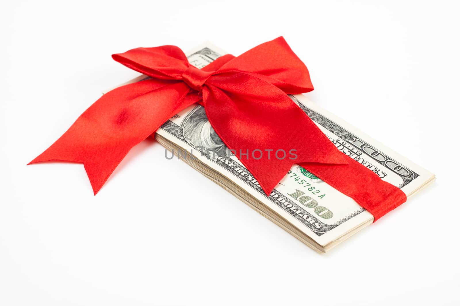 dollars wrapet up with a red ribbon isolated on white background