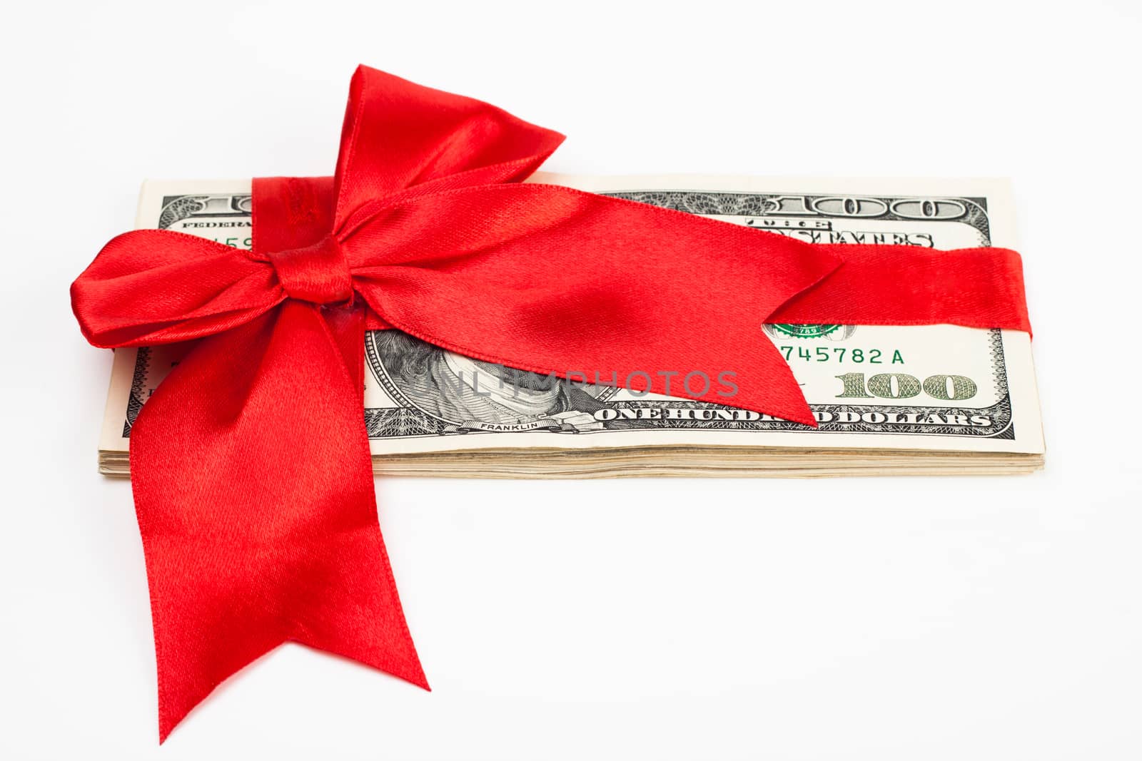 dollars wrapet up with a red ribbon isolated on white background