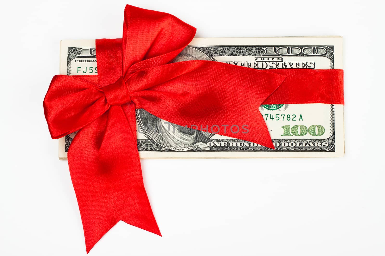 dollars wrapet up with a red ribbon isolated on white background