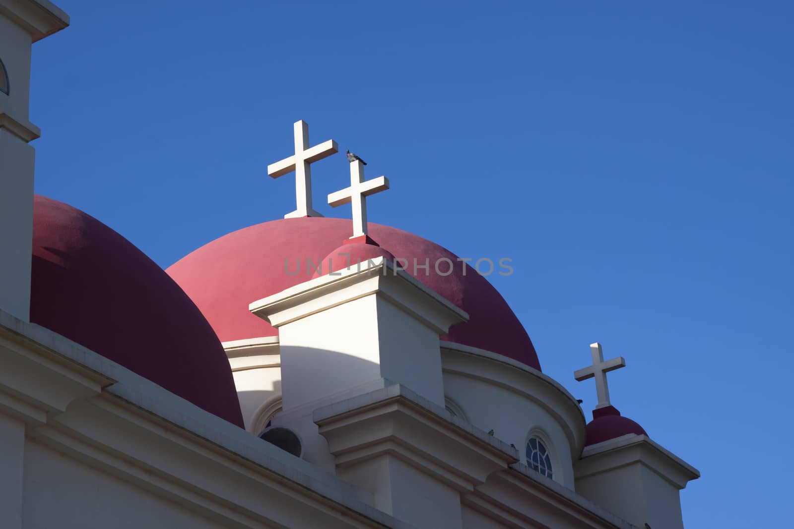 orthodox church  on the shore of sea of galilee blue sky in the background