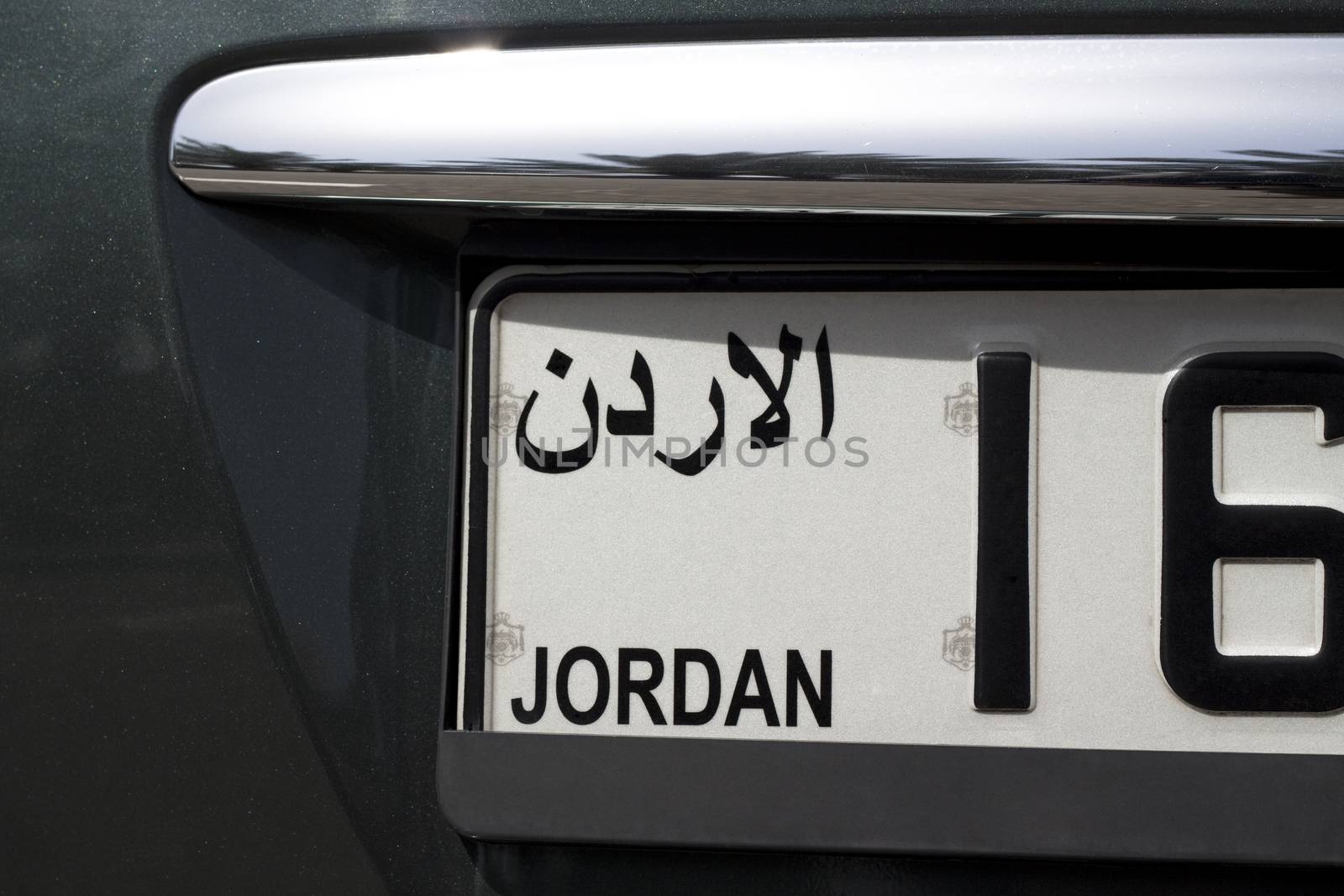 white jordanian licence plate on a shiny black  car