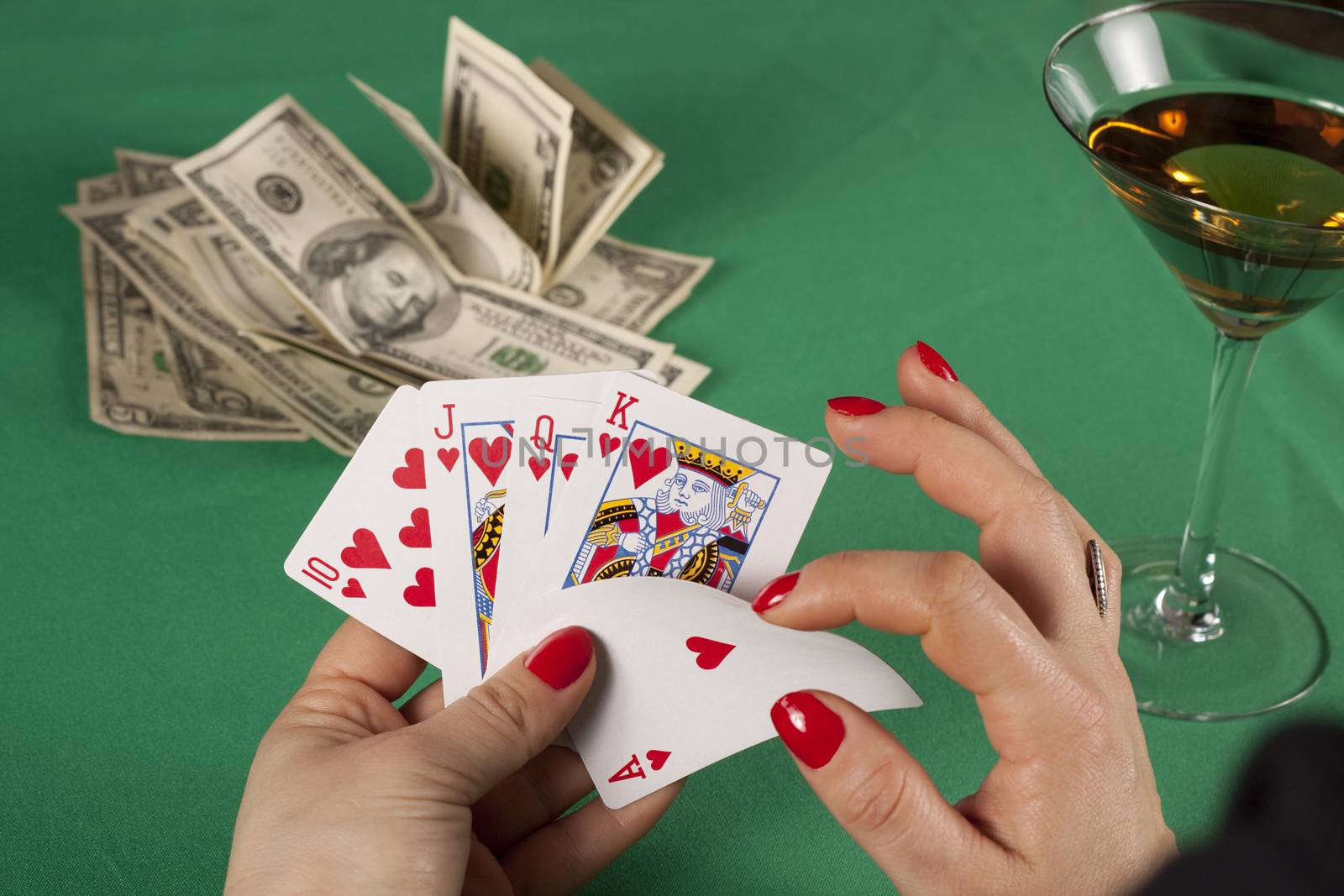 poker cards on green table with dollars