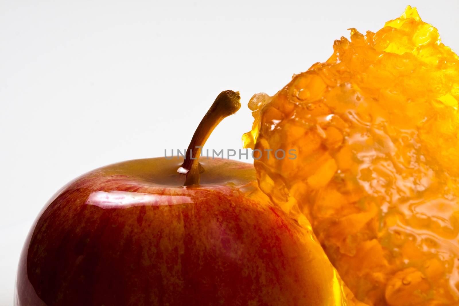 apple and honeycomb closeup on  white background