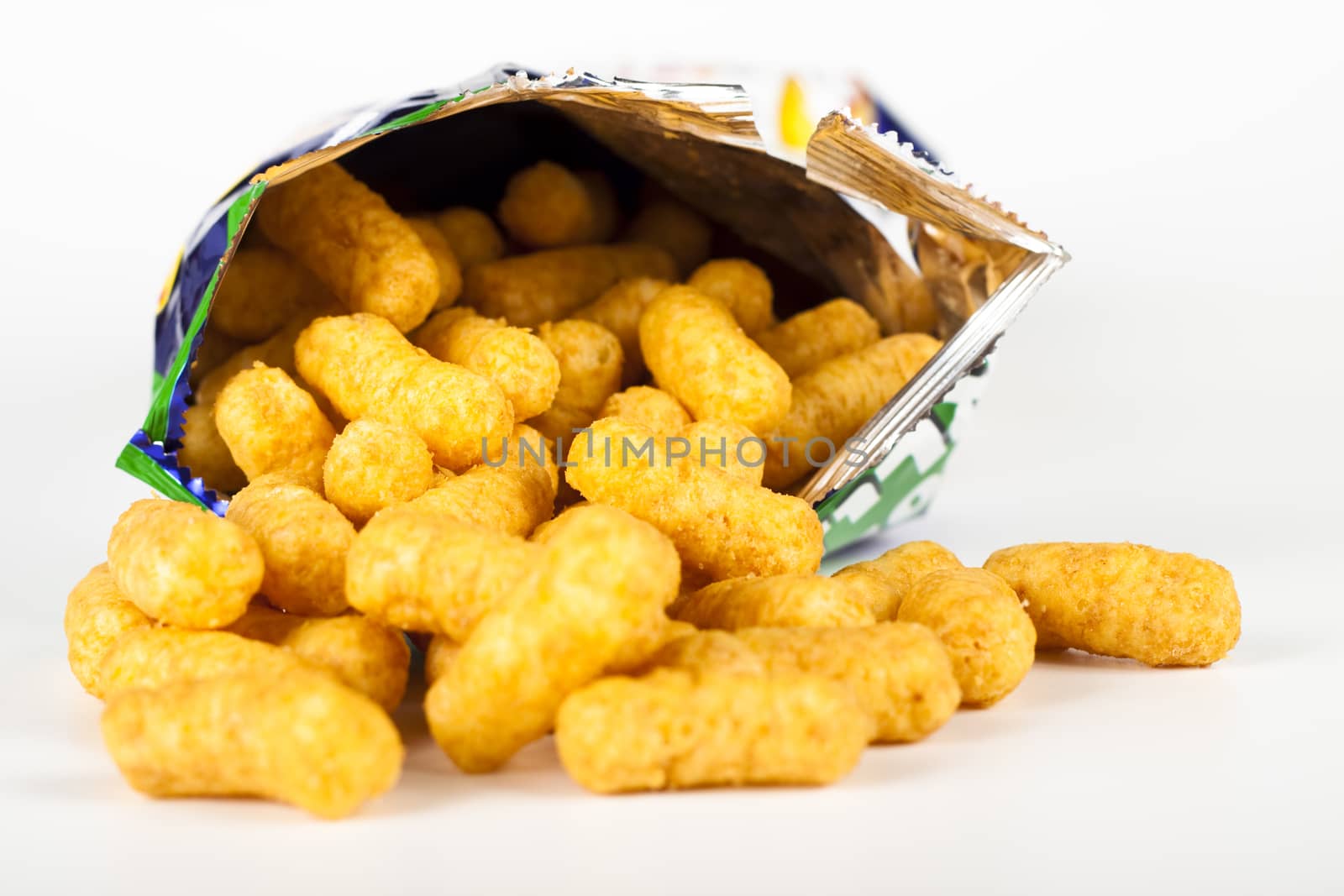 bamba unhealthy snacks out of the bag on white background