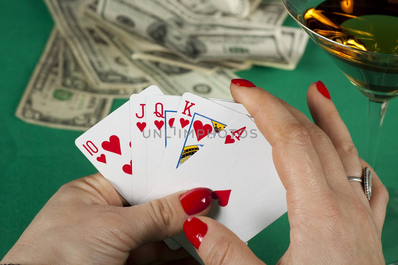 poker cards on green table with dollars