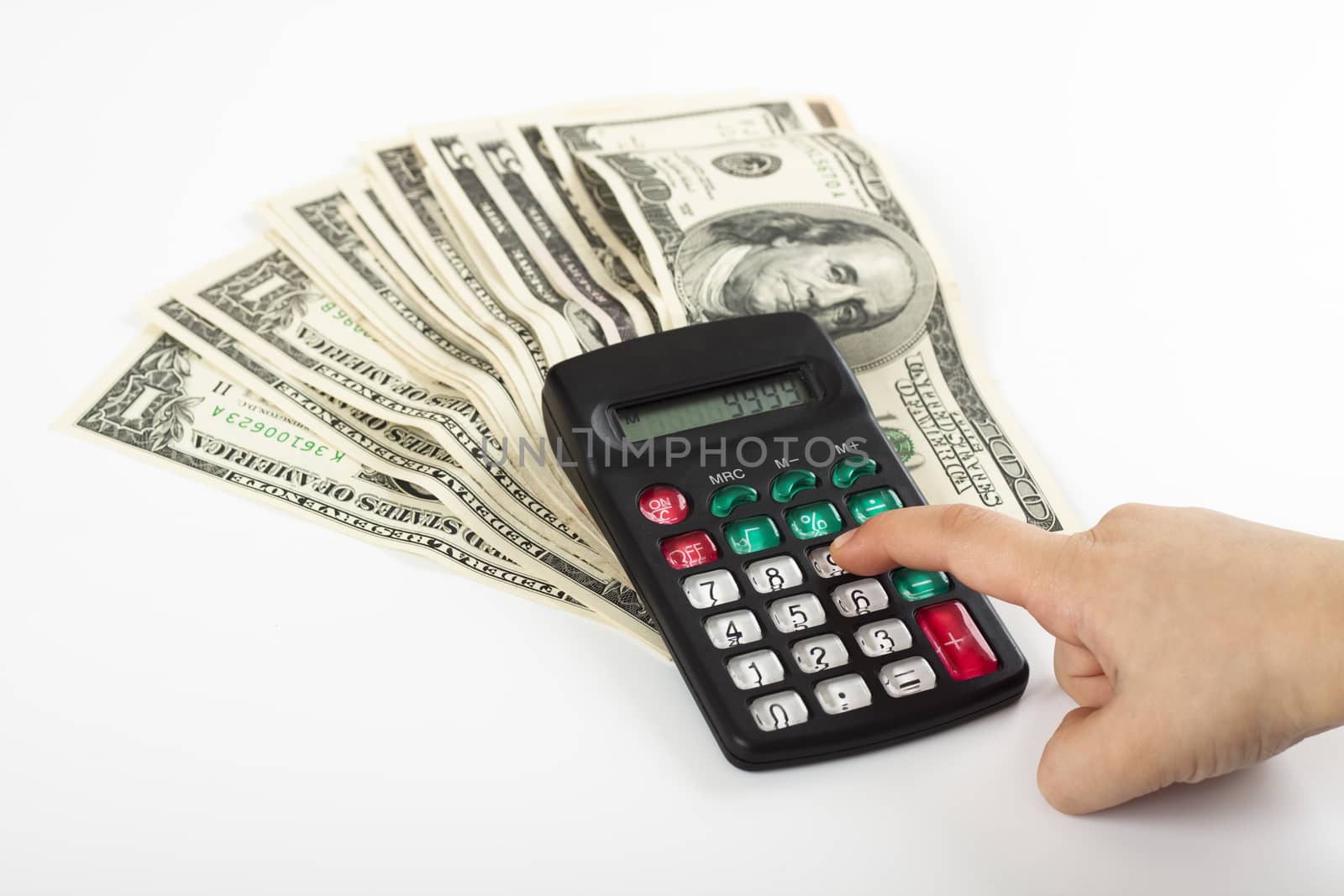 a child calculating expancess on a calculator that stands on  a couple of dollars