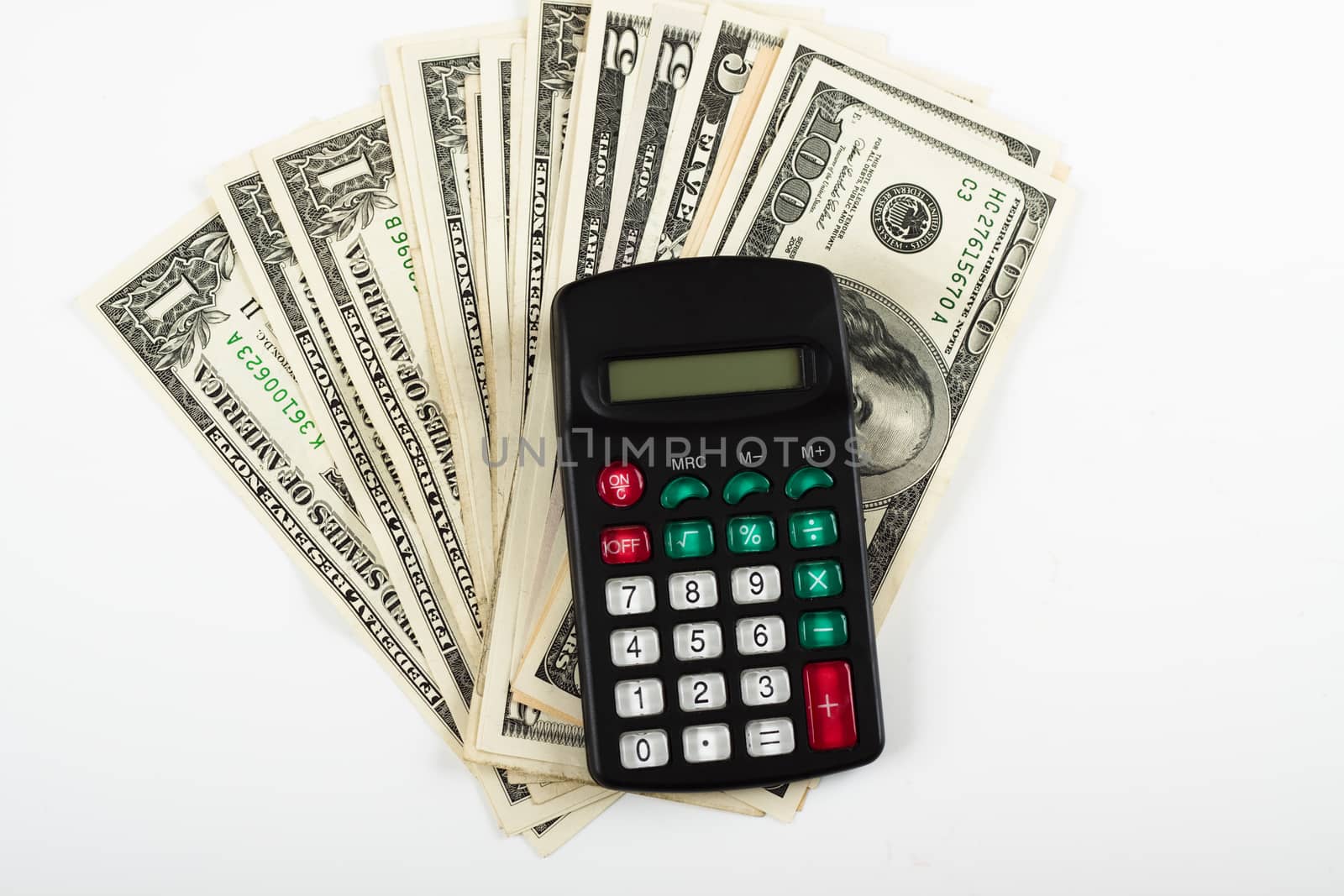 dollar bills with small black calculator on white background
