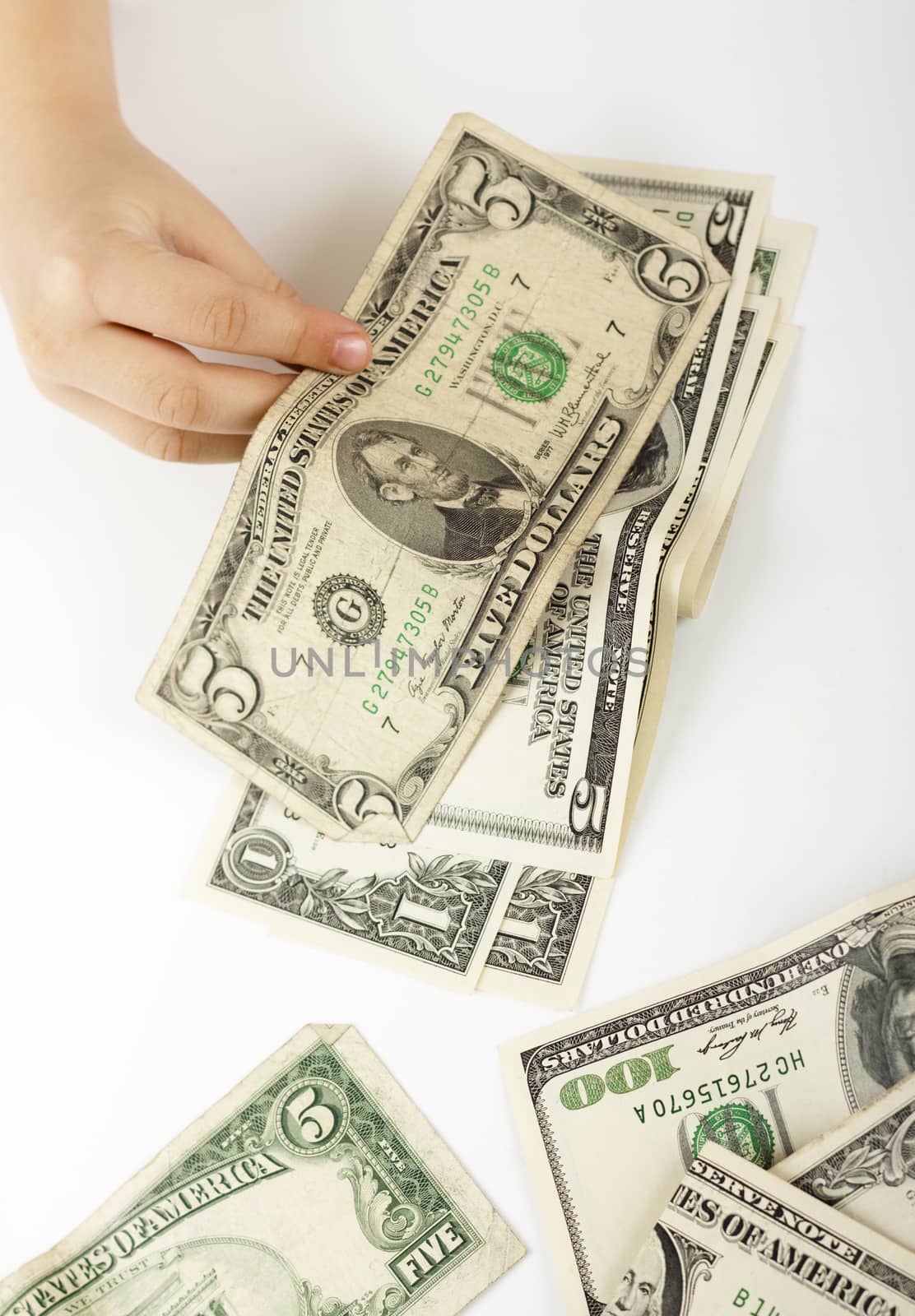 child hand counting dollar bills on white background