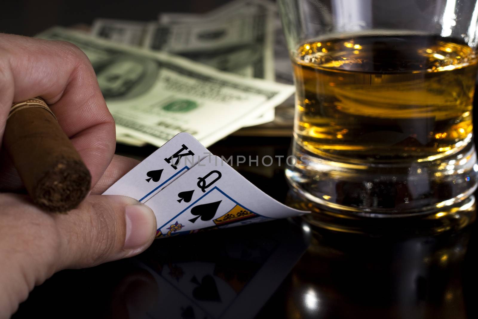 poker playing cards dollars and a whiskey glass