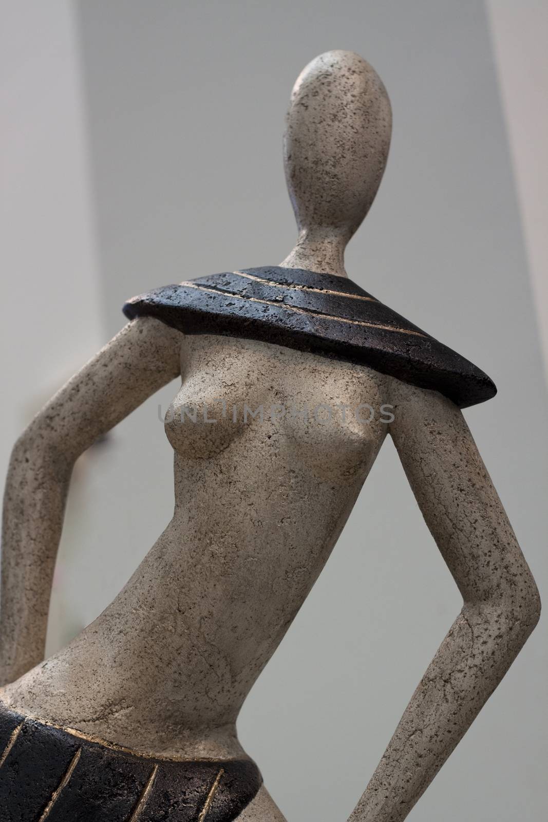 abstract woman statue made of stone with naked breast and no face