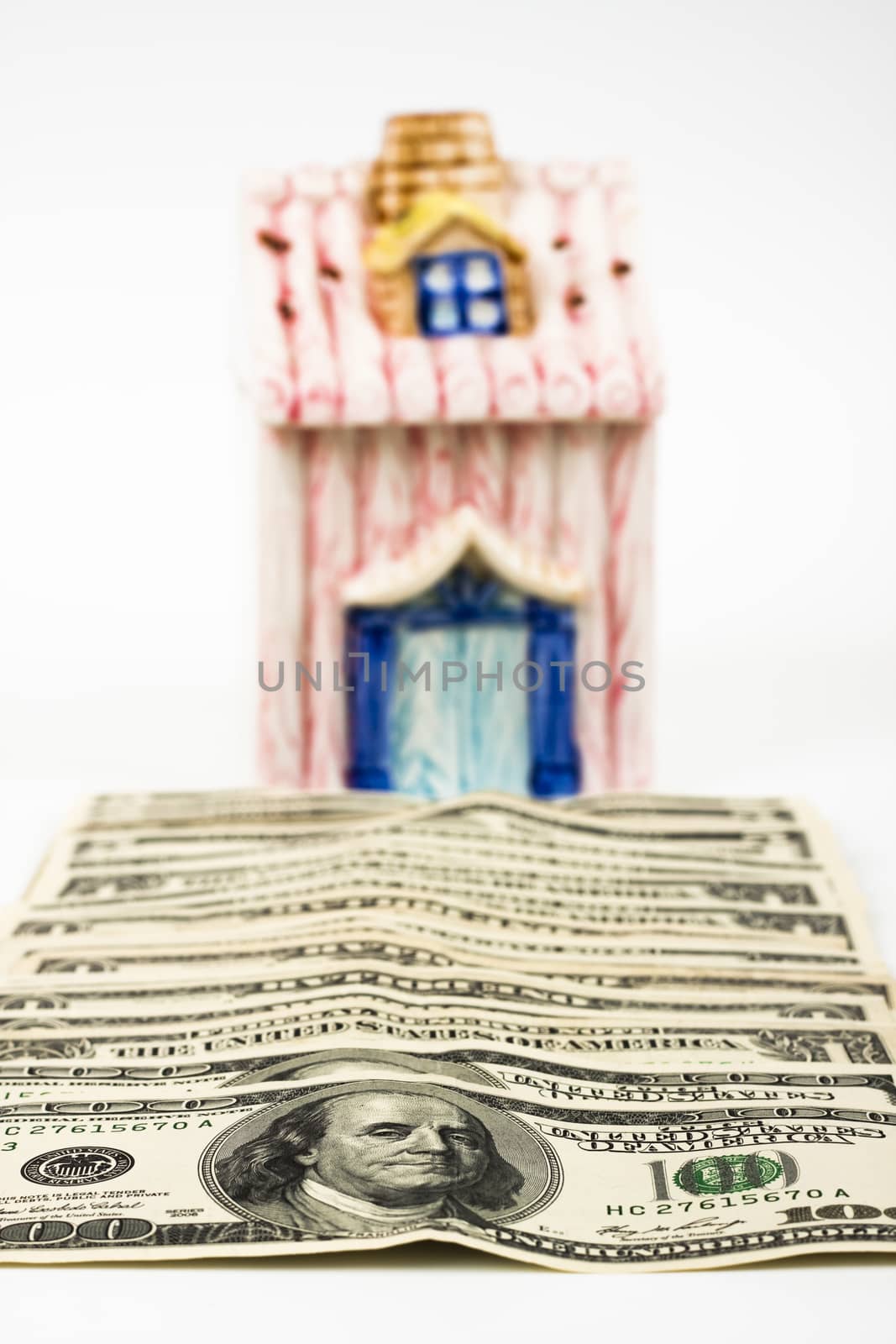 dollar bills leading to a new home on white background