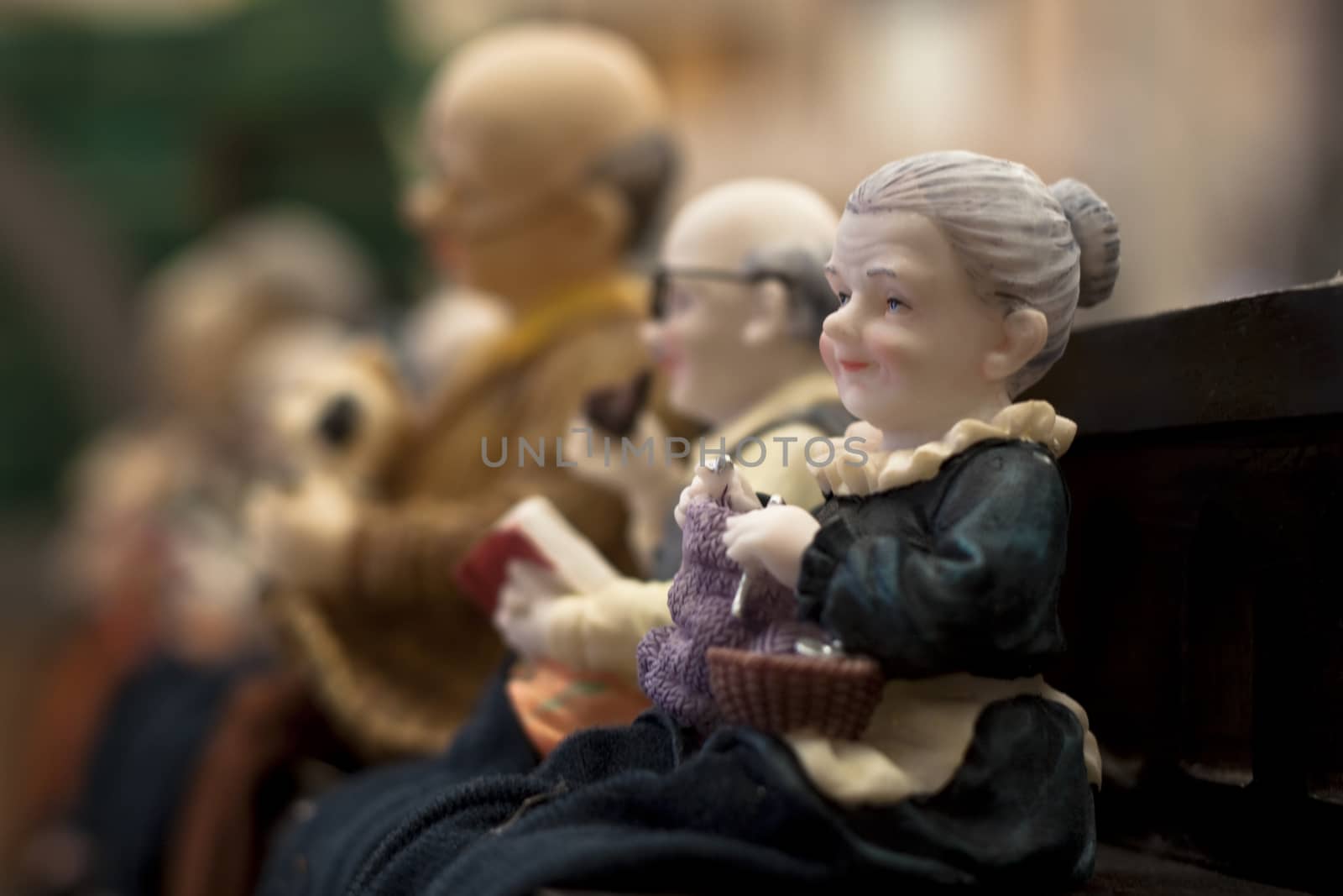 old women decorative doll in a row with other dolls