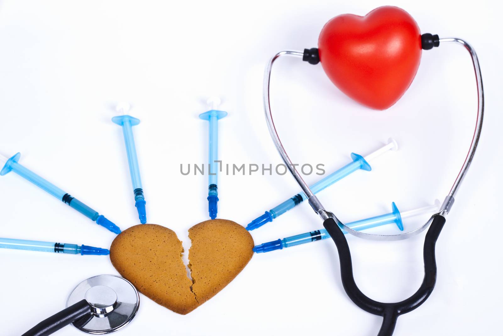 healing a broken heart with blue sirenge and a stethhoscope