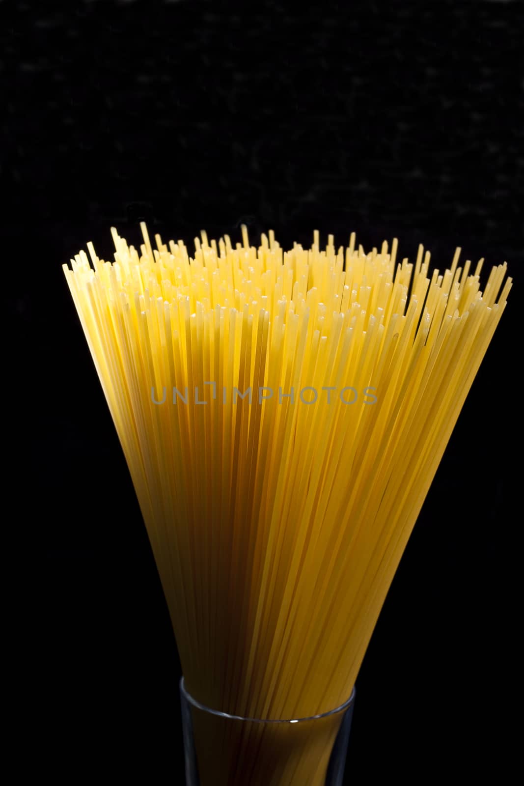 spaghetti in a glass abstrack light in black background