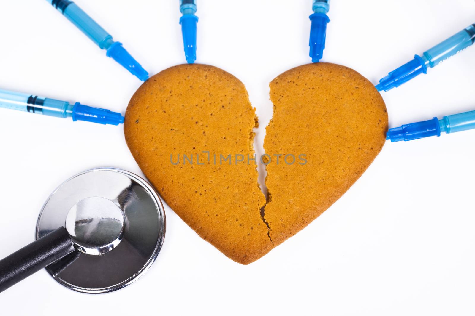 healing a broken heart with blue syringe and a sthethoscope on white background