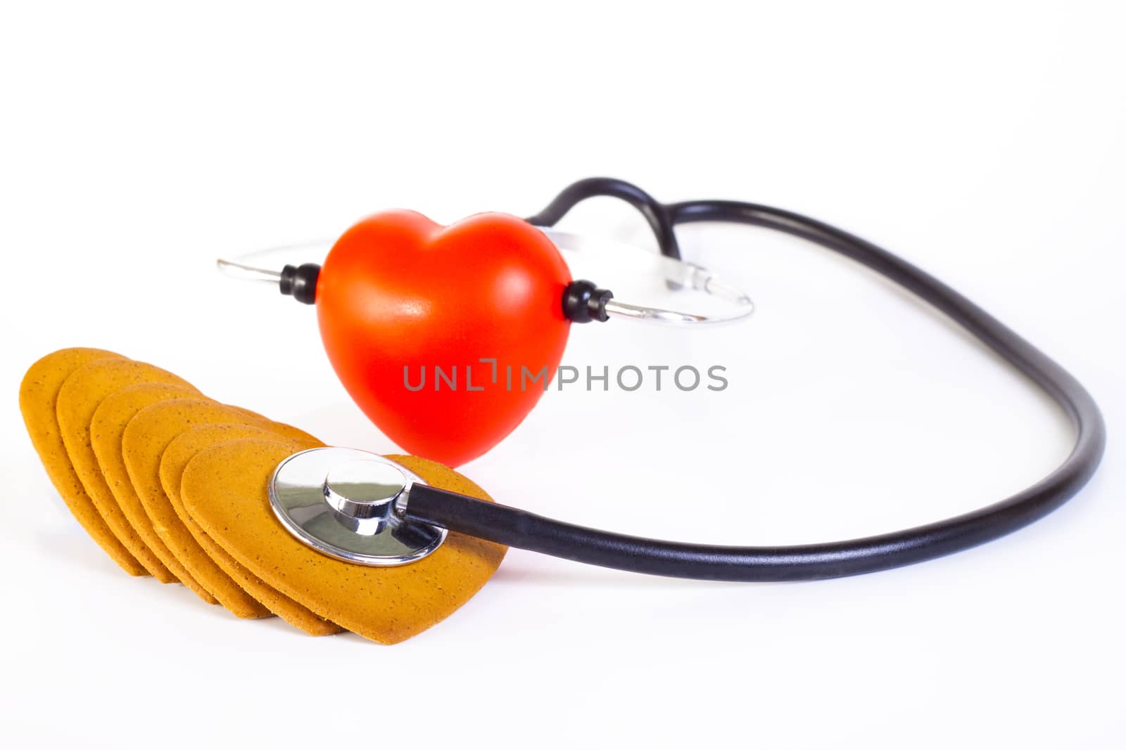 red hart wits a stethoscope  examining brown ginger bred hearts