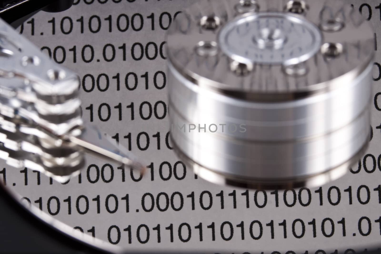 open spinig hard drive closeup on reading head with binary reflected data