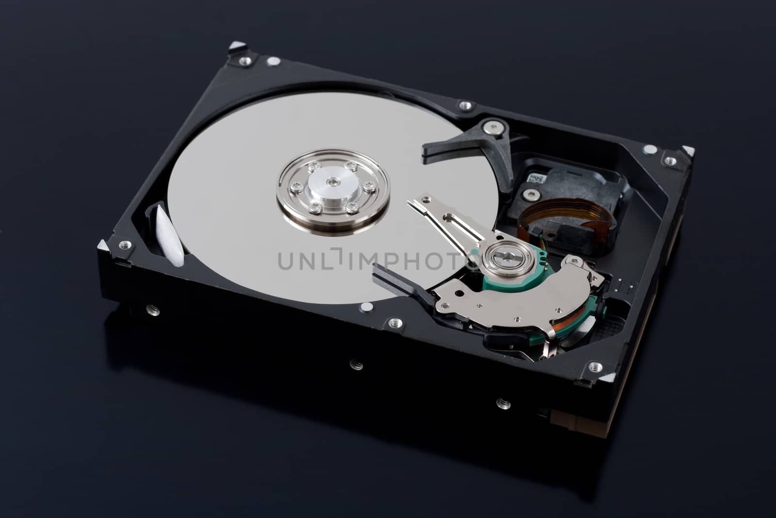 dissasembled hard drive upper view on black background