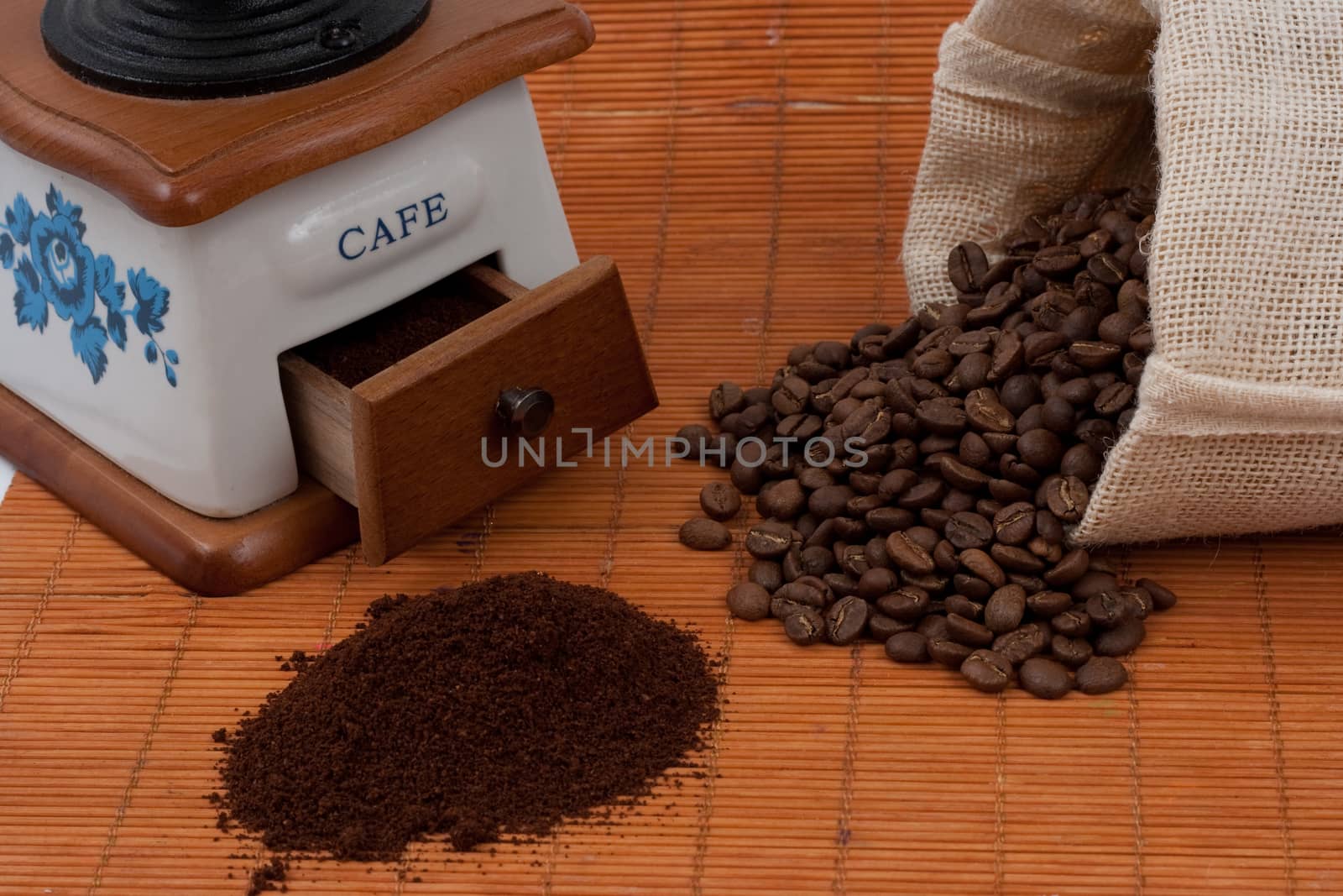 coffee beans from a bag and a grinder
