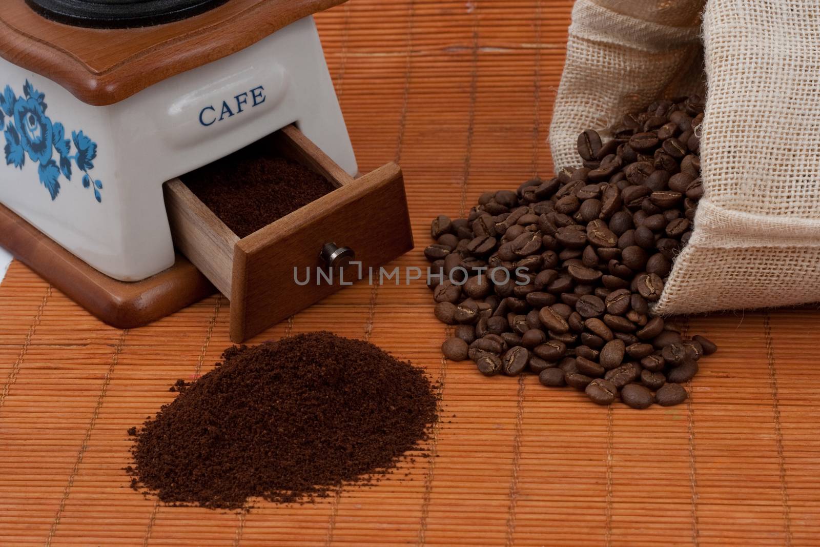 coffee beans from a bag and a grinder