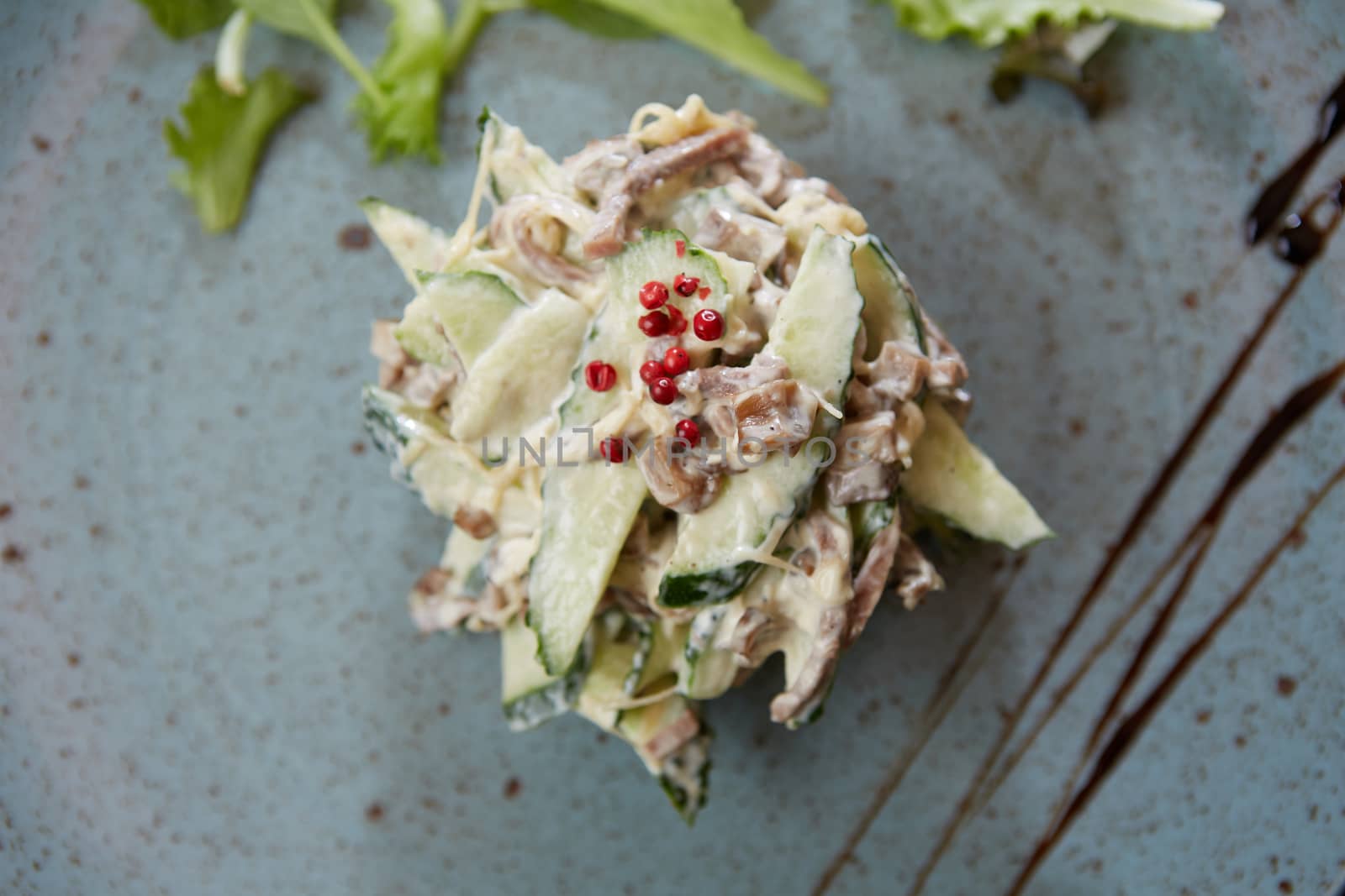Boiled beef tongue, marinated onion and peas salad with mayonnaise dressing, russian cuisine.