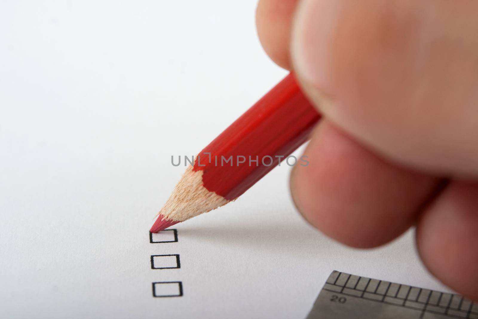 black checkbox on white page and red pencil
