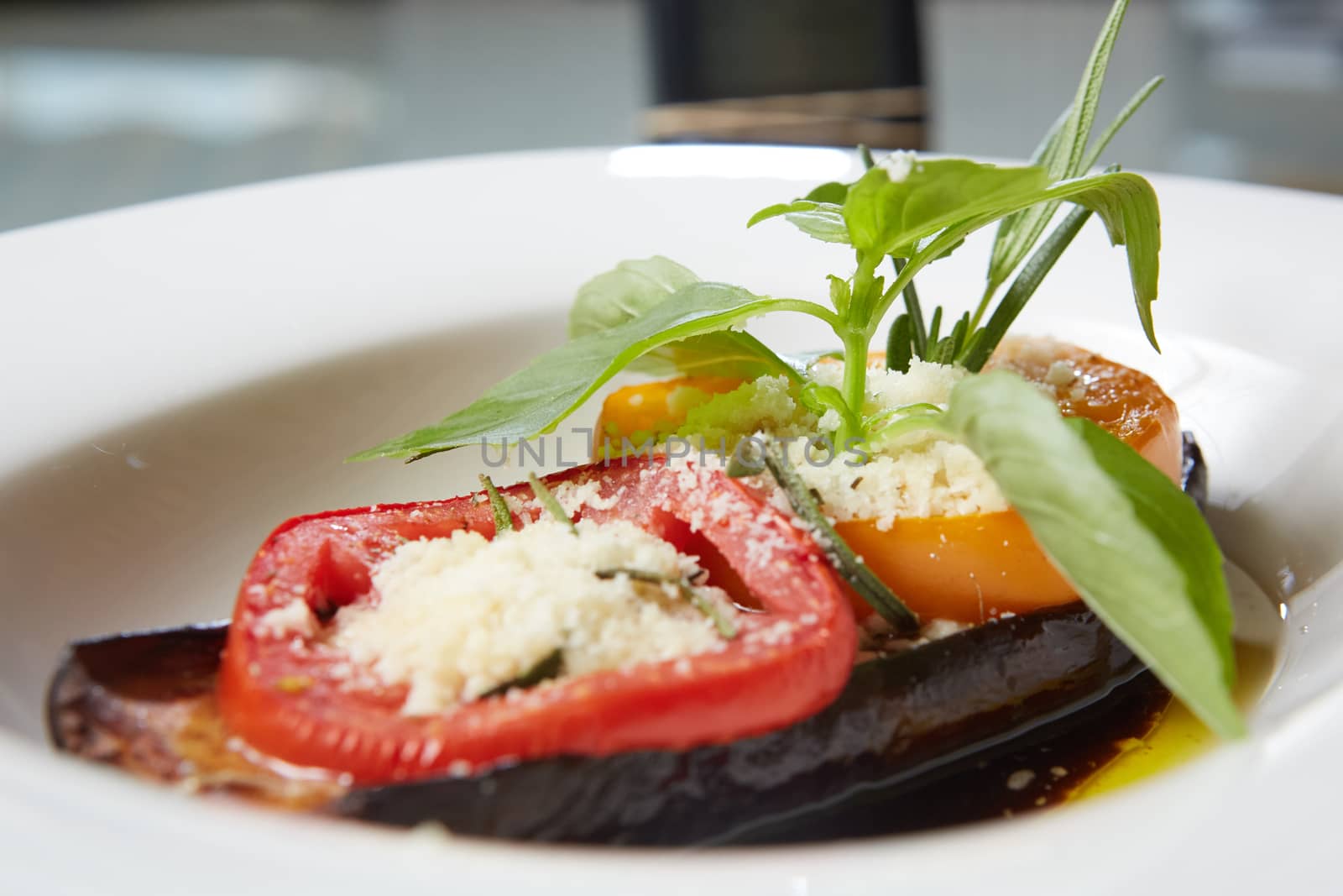 Baked eggplant with parmesan cheese, tomatoes and basil