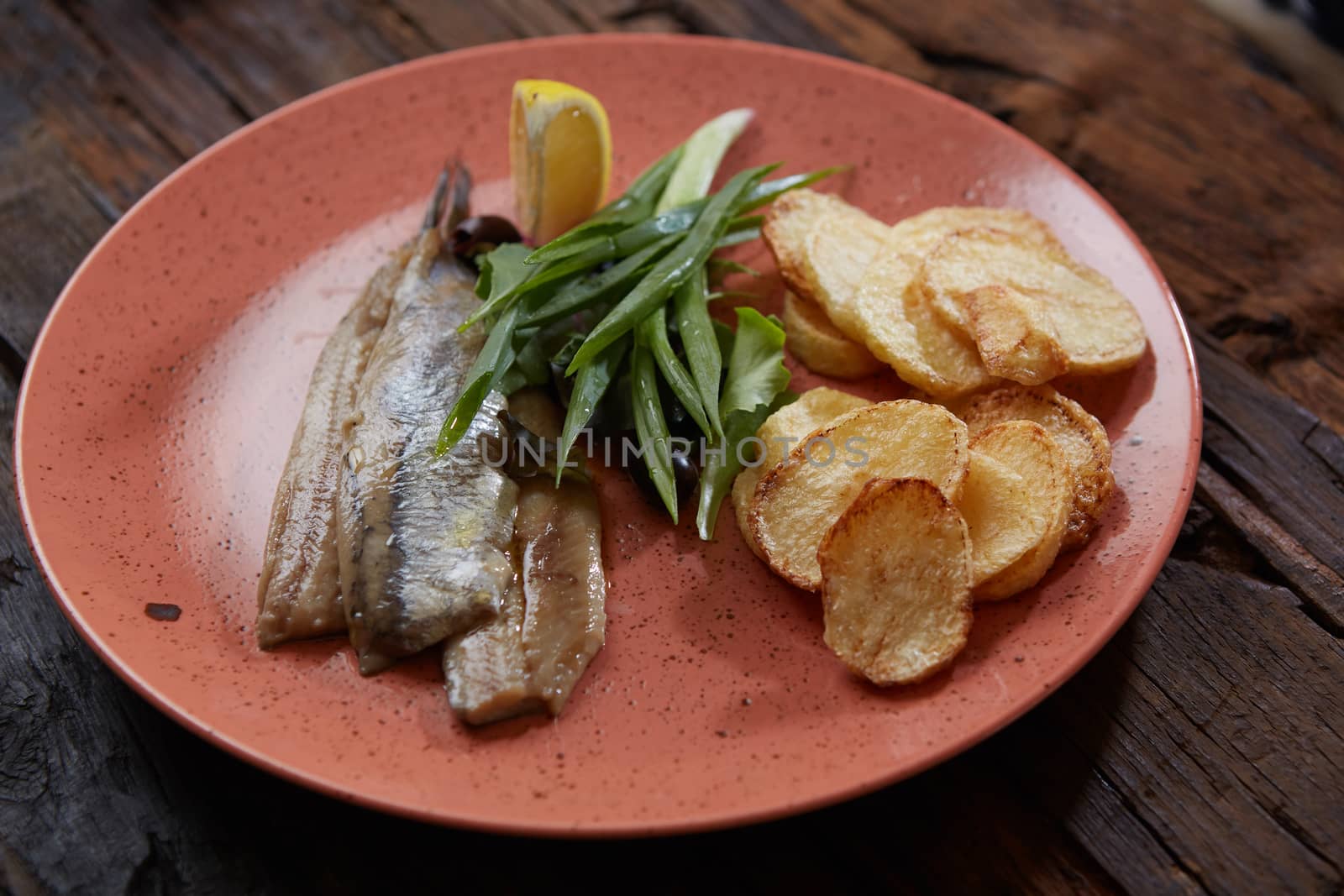 Pacific herring with fried potatoes and onion.