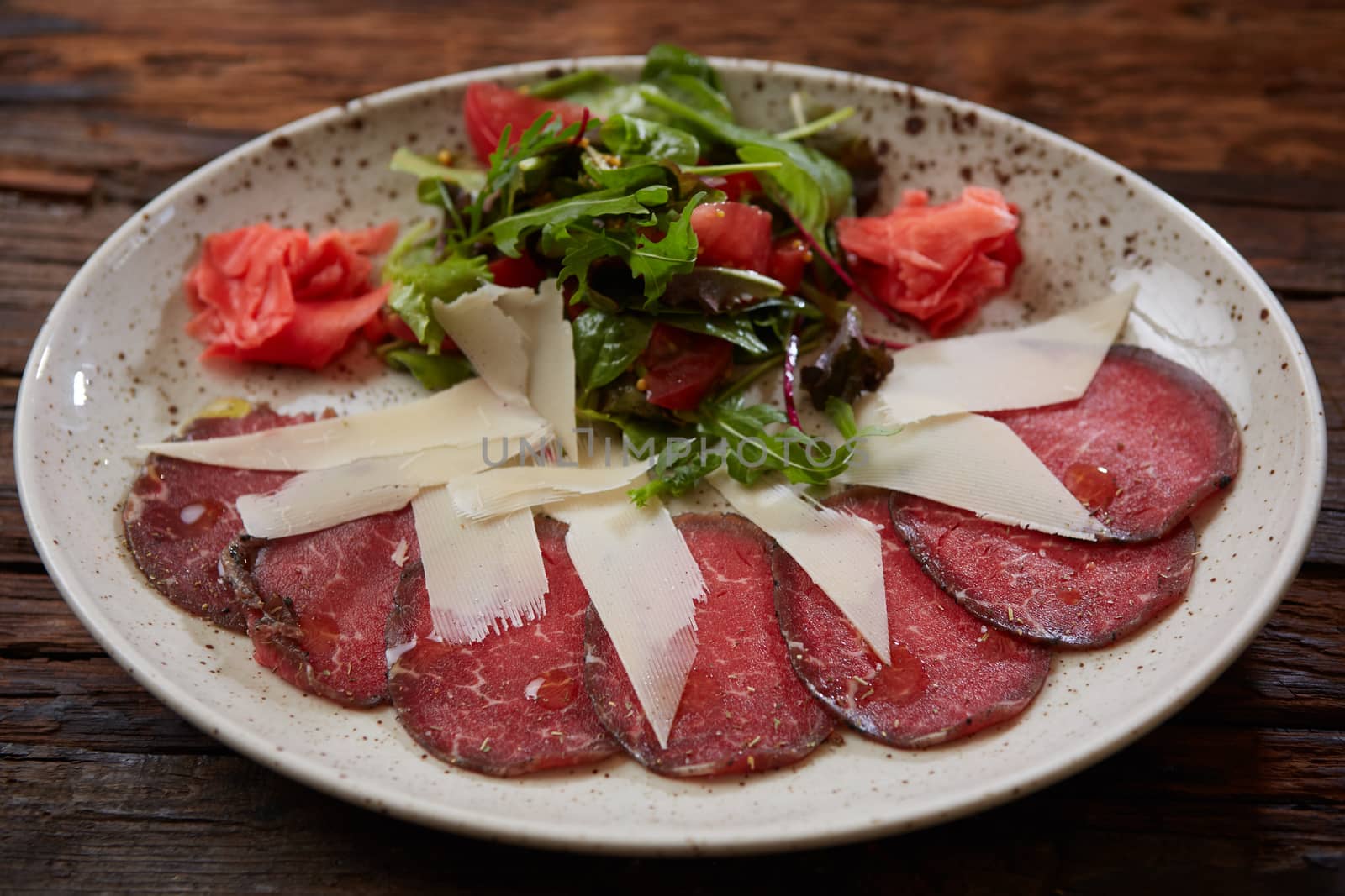 The carpaccio with cheese and salad top view.