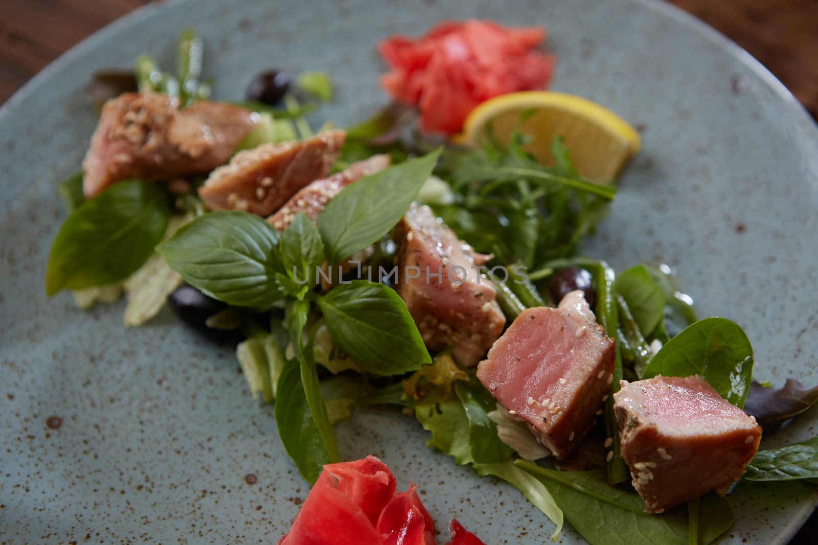 beautiful food: steak tuna in sesame, lime and fresh salad close-up on a plate on the table. horizontal