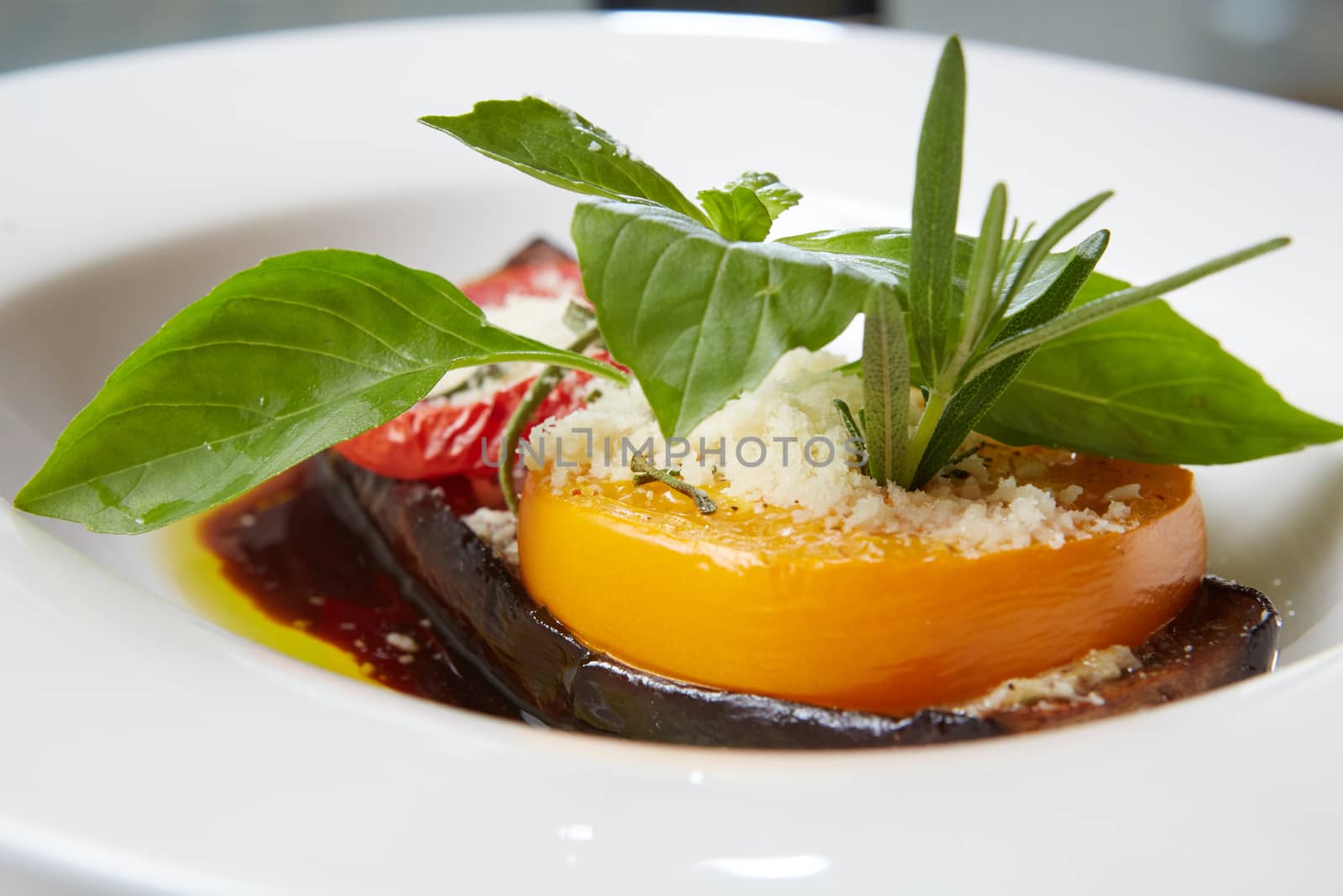 Baked eggplant with parmesan cheese, tomatoes and basil