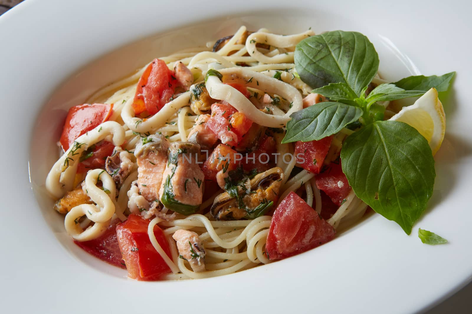 Seafood pasta Spaghetti with Clams, Prawns, Seafood Cocktail close up.