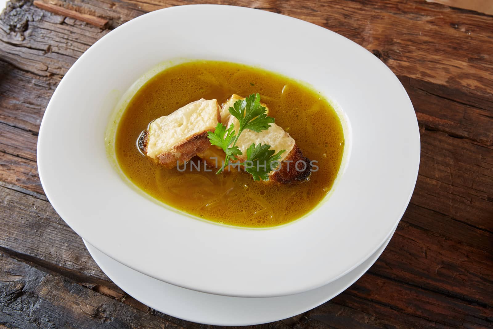 Onion soup in the ceramic pot. Shallow dof