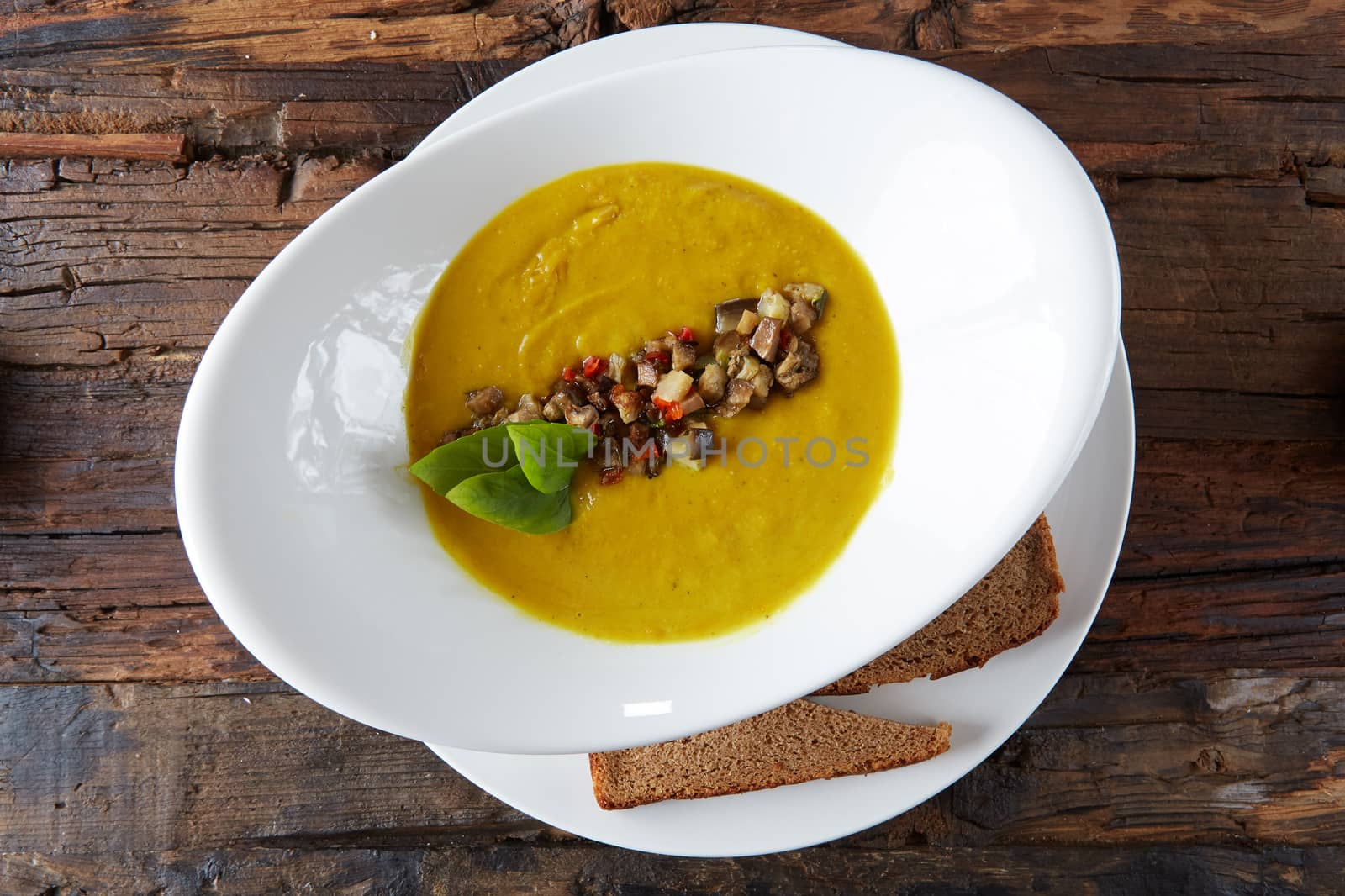 Healthy vegetable cream soup with herbs. Top view