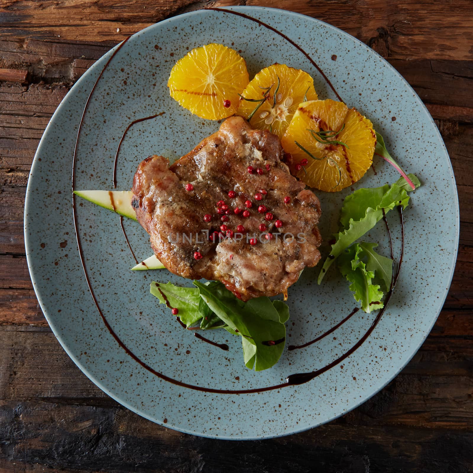 Chicken Steak with oranges and greens. Shallow dof. by sarymsakov