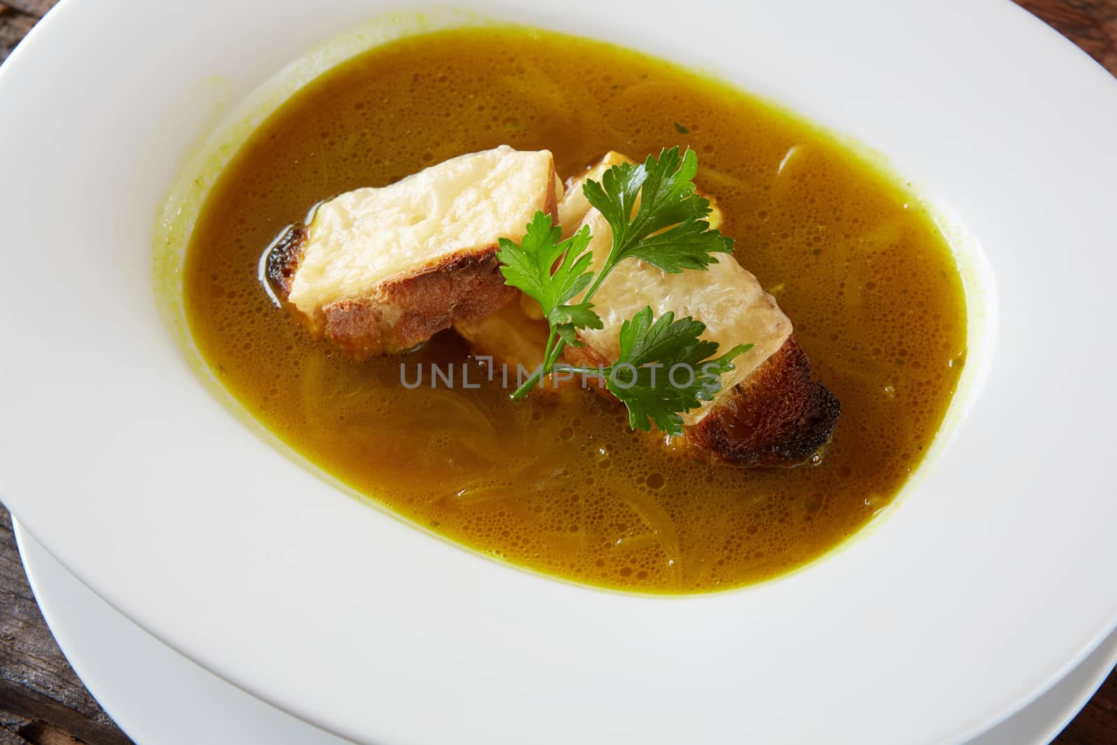 Onion soup in the ceramic pot. Shallow dof