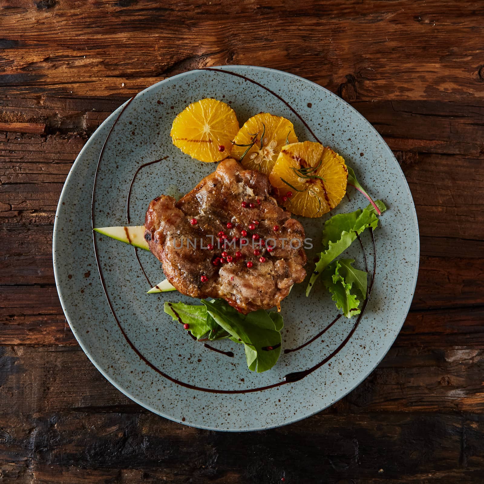 Chicken Steak with oranges and greens. Shallow dof