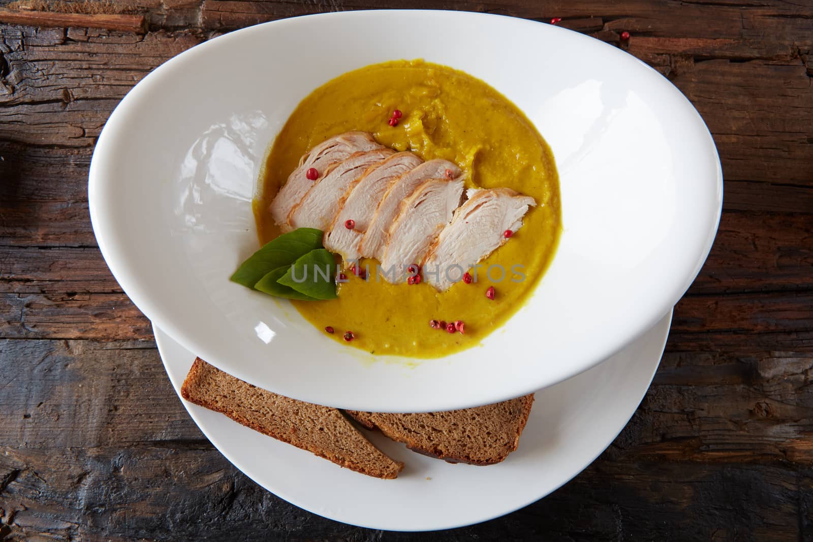 Pumpkin and carrot soup with chicken. Top view. Copy space